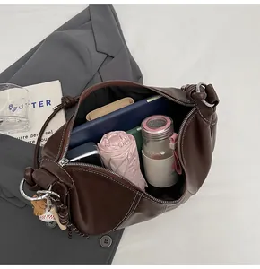 Deep brown crossbody bag with large capacity showing interior storage and knot detail