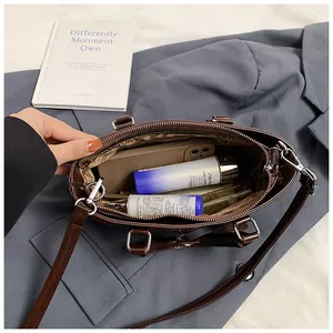 Interior view of large leather tote bag showing spacious capacity for phone and cosmetics