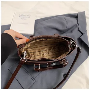 Interior view of vintage brown tote bag showing branded lining and silver hardware details