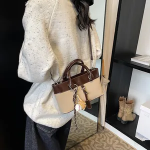 Vintage large tote bag in brown and beige leather patchwork with sports charm pendant