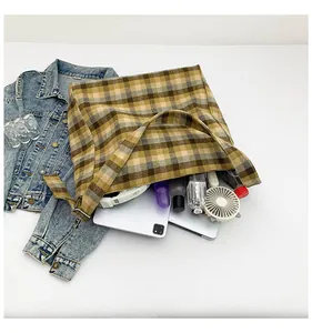 Top view of large plaid tote bag showing spacious interior with tablet and daily items