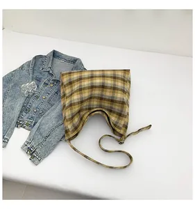 Detailed flat lay of plaid tote bag with yellow and brown checkered fabric pattern