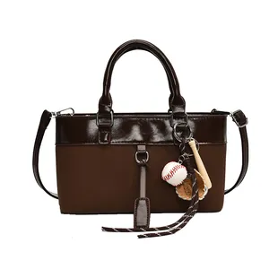 Brown two-tone large capacity tote bag with baseball charm and adjustable strap