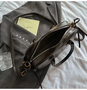 Top view of spacious dark coffee leather bag with golden zipper and interior detail