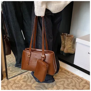 Brown vintage faux leather tote bag with gold buckle and matching coin purse charm