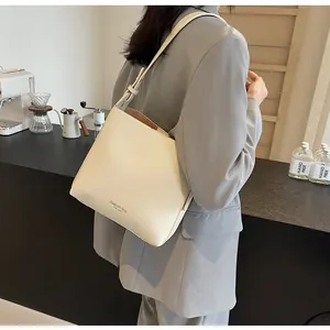Detail of off-white minimalist bucket bag with adjustable strap and fashion bag logo