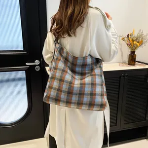 Fashionable oversized plaid tote bag in blue and brown fabric for women's winter style