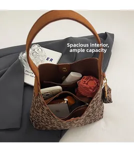 Detailed view of the leopard print tote bag interior showing spacious storage and pockets