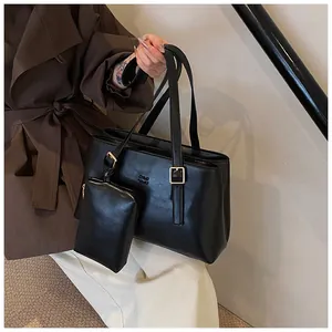 Detail of black faux leather tote with CHLO SMU embossing and golden metal hardware