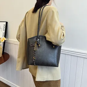 Retro charcoal tote bag with slim shoulder straps and decorative metal mesh charm