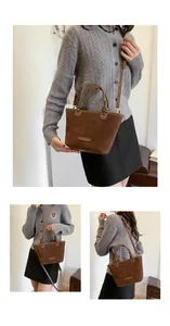 Detail of a brown suede tote bag featuring metallic logo and adjustable crossbody strap