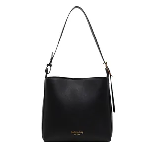 Minimalist black PU leather bucket bag with wide adjustable strap and gold logo