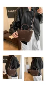 Detail view of the vintage dark brown suede tote bag with handle and shoulder strap