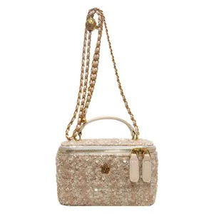 Champagne tweed vanity bag with sequins, adjustable gold chain, and floral ornament