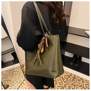 Dettaglio della grande borsa tote in pelle PU oliva con nodo intrecciato e spalline sottili