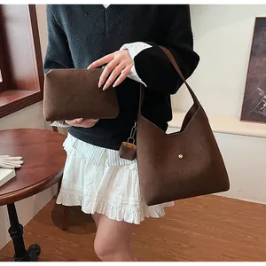Three-piece brown suede tote bag set with matching clutch and mini pouch accessory