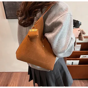 Detail of caramel suede oversized tote bag with matching mini pouch accessory