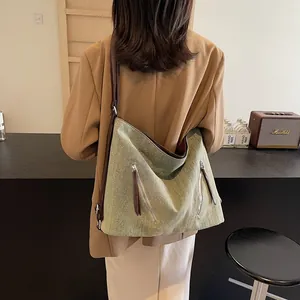 Women's large avocado green canvas hobo bag with adjustable brown leather straps