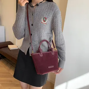 Vintage burgundy suede tote bag with stylish knot handle for versatile crossbody or hand carry