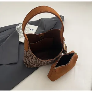 Detailed top view of leopard print and brown suede bucket bag set with inner pouch
