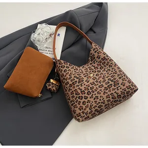 Detailed set of leopard print shoulder bag with matching mini charm and brown pouch