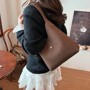 Large dark brown suede Hobo bag with minimalist gold buckle shown on female model