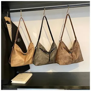 Three large retro tote bags in light brown, dark green, and dark coffee on metal hooks