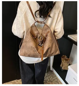 Detailed back view of a vintage brown leather tote bag used as a stylish backpack