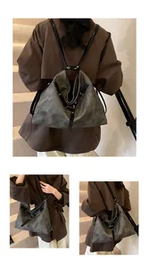 Detail of vintage grey textured leather backpack showing multi-way strap functionality