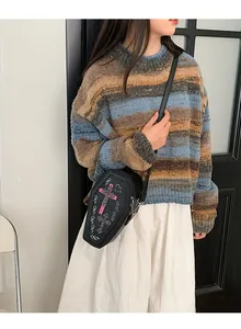 Gothic coffin-shaped crossbody bag with pink glitter cross on striped sweater model
