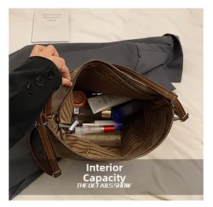 Detail view of the large capacity interior with striped lining for vintage tote bag