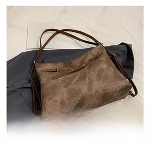 Macro shot of retro brown leather tote with marble texture and delicate metal ring details
