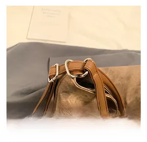 Detail of adjustable dark brown strap and silver metal buckle on a retro canvas tote bag