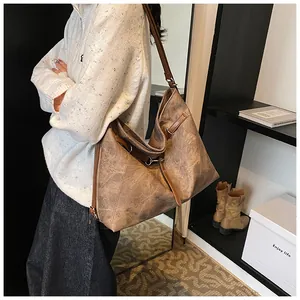 Detail view of a vintage brown large capacity tote bag with distressed leather texture