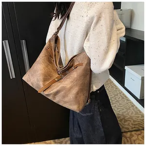 Side view of large vintage brown leather tote bag showing capacity and retro texture