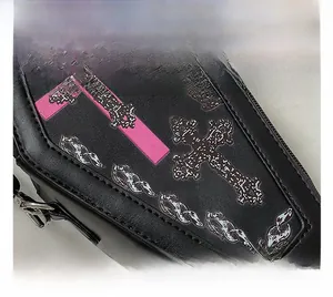 Close-up of black PU leather punk bag with pink cross print and fine stitching
