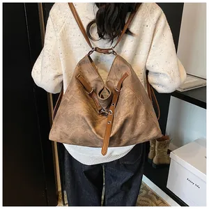 Detail of vintage brown soft leather backpack with adjustable straps and metal buckles