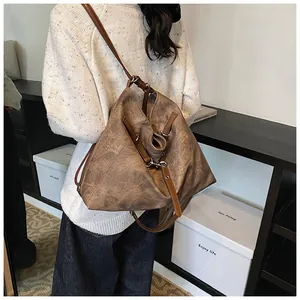 Back view of model wearing a large vintage dark brown leather tote bag for daily commute