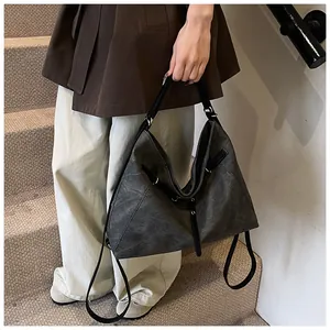 Close-up of vintage large capacity grey tote bag with side straps and long metal zippers