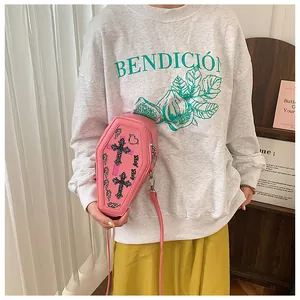 Detail of pink coffin-shaped crossbody bag with cross prints and Baby Girl lettering