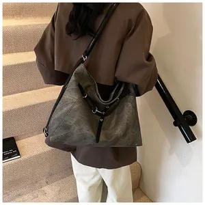 Detailed back view of charcoal grey retro tote bag with black straps and silver rings