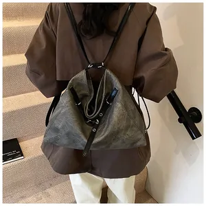 Detail of vintage grey large capacity backpack with textured leather and metal ring buckles