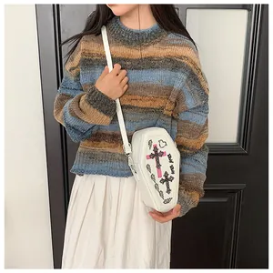 Detailed view of white coffin crossbody bag with gothic cross embroidery and slim strap