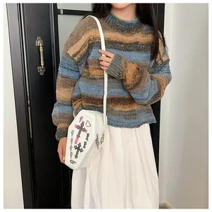 Lifestyle shot of white coffin-shaped crossbody bag with pink cross print on female model