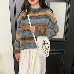 Gothic coffin-shaped crossbody bag with cross print and colorful striped knit sweater