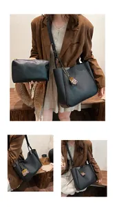 Close-up of black lychee grain tote bag set with leopard print charm detail