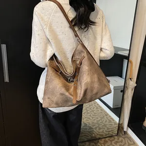 Vintage large capacity brown leather tote bag worn by model in a casual lifestyle setting