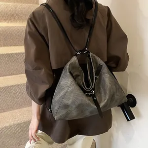 Versatile grey washed large capacity tote bag worn as a shoulder and backpack