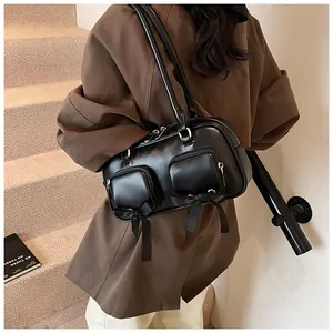 Close-up of black PU leather shoulder bag with side bow details on a fashion model