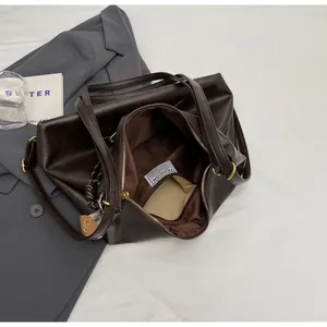 Detail view of spacious brown tote interior with zip pocket and soft PU leather texture